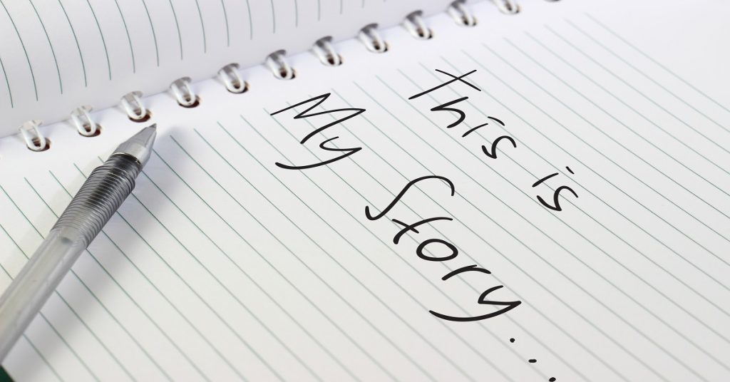 Image of opened white note book with a pen, and This Is My Story words written on it
