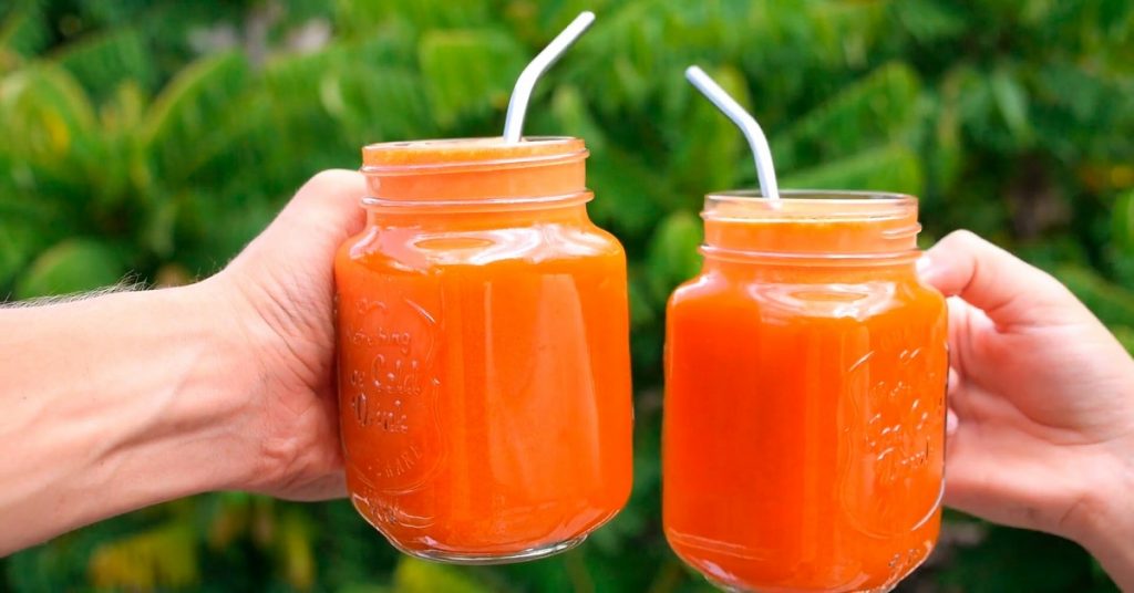 two clink glasses with smoothies