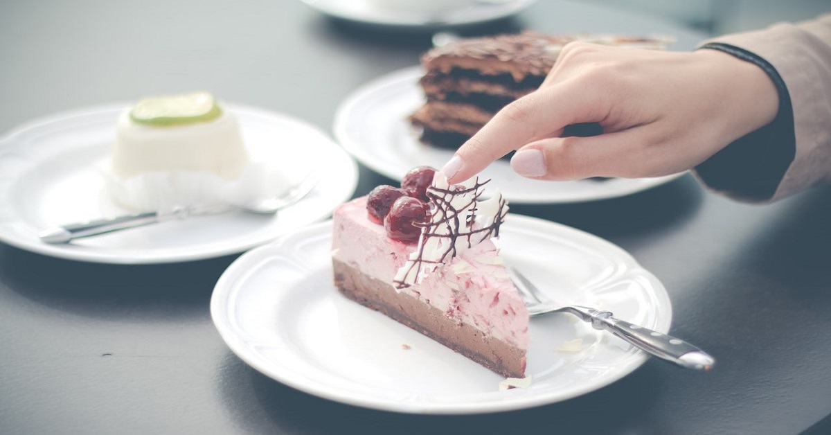 woman touching cake with finger